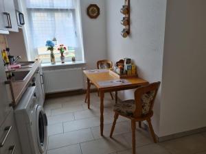 a kitchen with a table and a washing machine at Ferienwohnung Lange in Burgstaedt