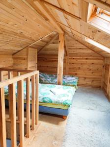 a room with a bunk bed in a wooden attic at Терасите - Къща 2 in Ribarica
