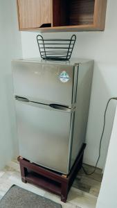 a refrigerator with a chair on top of it at Gensan Apartment Rental in General Santos