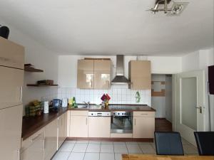 a kitchen with white cabinets and a stove top oven at Huge Private Room in Best Location in Düsseldorf