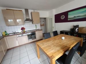 a kitchen with a wooden table and a dining room at Huge Private Room in Best Location in Düsseldorf
