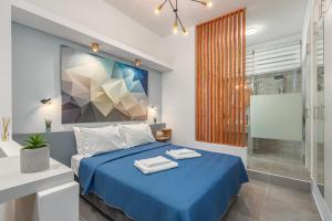 a bedroom with a blue bed and a shower at Theo's Cozy Apartment near Athens airport in Spata