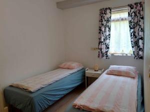 Uma cama ou camas num quarto em Bergistangi Guest House