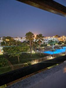 a view of a swimming pool at night at Condado De Alhama Golf Resort 2 Bedroom Apartment Jardine 13 in Murcia