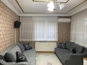 a living room with a couch and a television at Demir Apart in Trabzon