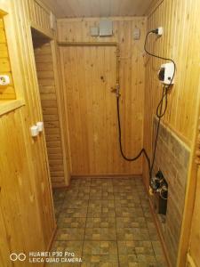 a bathroom with a shower in a wooden wall at Уют in Zharkent