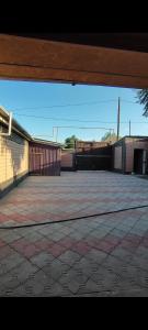 an empty parking lot with a fence and a building at Уют in Zharkent +13 photos