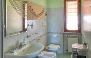 a bathroom with a sink and a toilet at Stunning Apartment In Montefiascone With Kitchen in Montefiascone