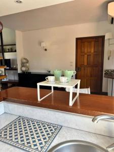 a kitchen with a table with two green bowls on it at Casa Wizzy in Vico Equense +45 photos