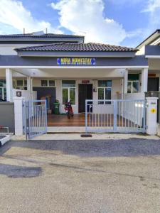 a white fence in front of a building at Mira Homestay Gurun - Pendang in Pendang