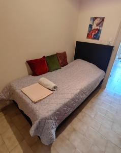 a bed with two pillows on it in a room at Leonidas Private Apartment in Sparta in Sparta