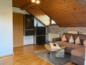 a living room with a couch and a table at Ferienwohnung Auersbergsreut in Haidmühle
