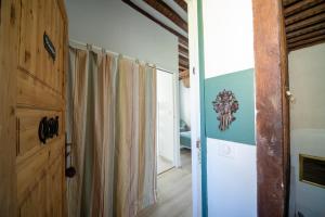 a hallway with a door and a curtain in a room at Le Clos de la Tour 