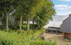 an rv parked next to the water with trees at 3 Bedroom Lovely Home In Børkop in Børkop +22 photos