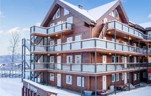 a large wooden house with snow on it at Lovely Apartment In Geilo With Wifi in Geilo