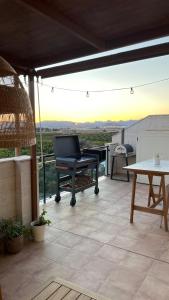 a piano sitting on top of a patio with a table at Atico Canet de Berenguer in Canet de Berenguer