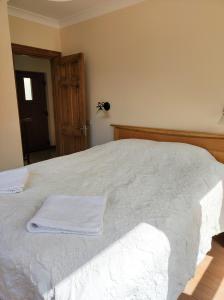 um quarto com uma cama com toalhas brancas em Терасите - Къща 3 em Ribarica