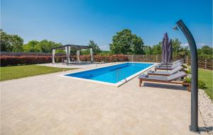a swimming pool with a gazebo next to at 3 Bedroom Stunning Home In Zminj in Žminj