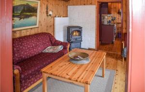 a living room with a couch and a wood stove at Nice Home In Rauland With Kitchen in Rauland