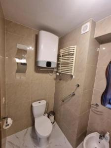 a bathroom with a toilet and a sink at Apartament Blisko Morza 59 in Kołobrzeg +11 photos