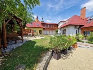 a house with a garden and a playground at Apartmány Comfort in Střílky