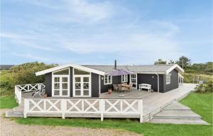 a modular home with a large deck and a house at Nice Home In Fan With Kitchen in Fanø