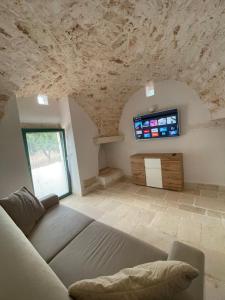 a living room with a couch and a tv at Lamia Millanta in Villanova di Ostuni