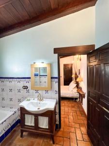 a bathroom with a tub and a sink and a bath tub at Hotel Servilia in Carmona