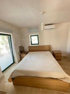 a bedroom with a large bed and a window at Lamia Millanta in Villanova di Ostuni