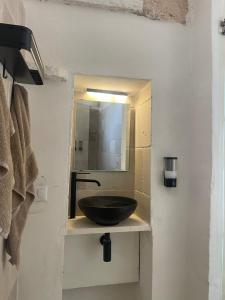 a bathroom with a sink with a mirror at Lamia Millanta in Villanova di Ostuni +26 photos