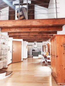 a large living room with wooden ceilings and a dining room at Casa Ginevra in Cagliari