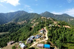 a village on the side of a mountain at Mount Mahabharat Homestay in Panaoti