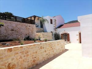 a stone retaining wall in front of a house at VILLA HALEPOURI in Chania Town