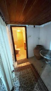 um quarto com uma casa de banho com um WC e uma porta em Ayvalık Aygün pansiyon em Ayvalik
