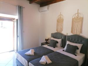a bedroom with two beds with towels on them at VILLA HALEPOURI in Chania Town +47 photos