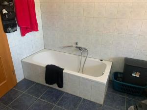a bath tub with a faucet in a bathroom at Ferienwohnung am Ponyhof in Altötting +15 photos