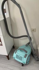 a vacuum cleaner on the floor next to a staircase at Deniz Apartment in Yalova