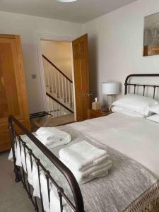 a bedroom with two beds with white towels on them at Stunning Georgian Period House in Kent