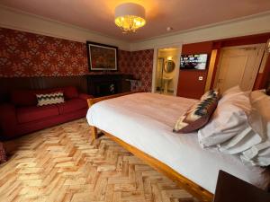 a bedroom with a large bed and a couch at The Dundrum Inn B&B in Dundrum