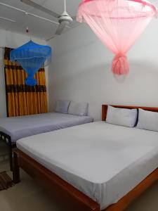 Postel nebo postele na pokoji v ubytování Pranu House
