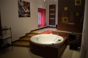 a bathroom with a bath tub and a staircase at La Residenza Piacentina in Vigolzone
