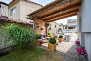 a backyard with a wooden deck with a pergola at APARTMANY L&O - Laura in Zvolenské Nemce