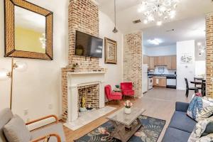 a living room with a couch and a fireplace at Historic District Apartment Quiet Street Central Location! in Mobile