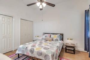 a bedroom with a bed and a ceiling fan at Historic District Apartment Quiet Street Central Location! in Mobile