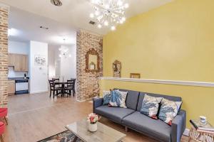 a living room with a couch and a table at Historic District Apartment Quiet Street Central Location! in Mobile