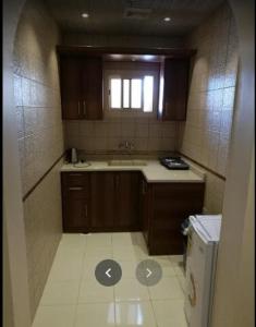 a small kitchen with a sink and a window at Zahret Al Madinah in Al Madinah