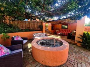a garden with a fire pit in the middle of a patio at Milky Way: Home with large garden, firepit & stars in Kenton on Sea