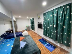 a room with a bed and a mural of flowers at Padang Besar Roomstay Firdaus in Padang Besar