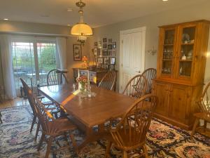 a dining room with a wooden table and chairs at Dodds Brick House Bed & Breakfast in North Hero