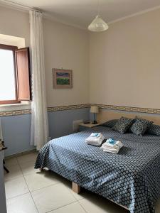 een slaapkamer met een bed met twee handdoeken erop bij La Casa al Piccolo Borgo in Vallo della Lucania
